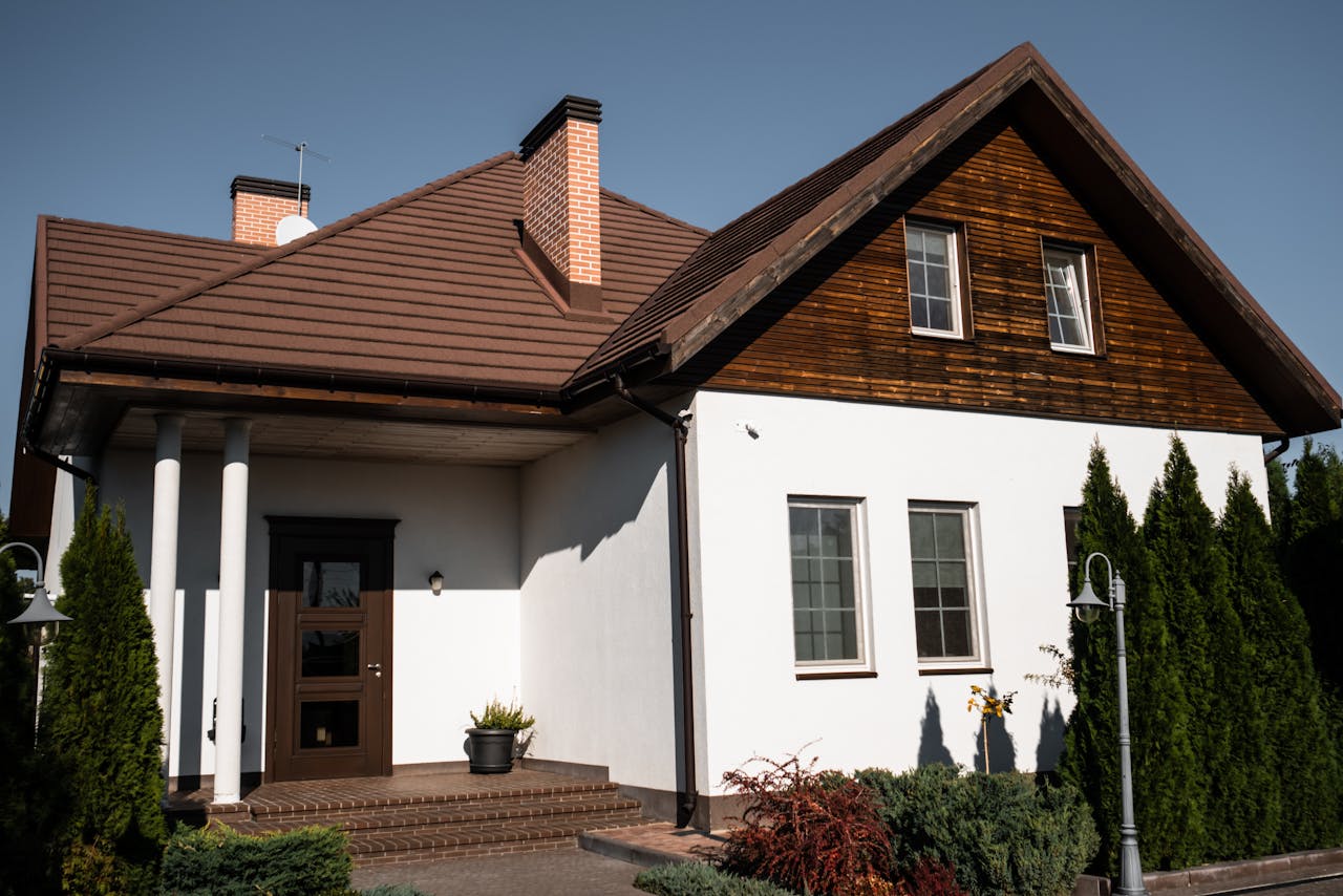 services-02 Charming modern bungalow with white facade and brown roof, ideal for architectural themes.